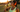 Eine Sportlerin trinkt während ihrer Laufeinheit an einem warmen Tag ausreichend Wasser.
